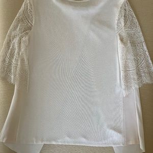 Knit ivory sweater with lace sleeves and back panel.